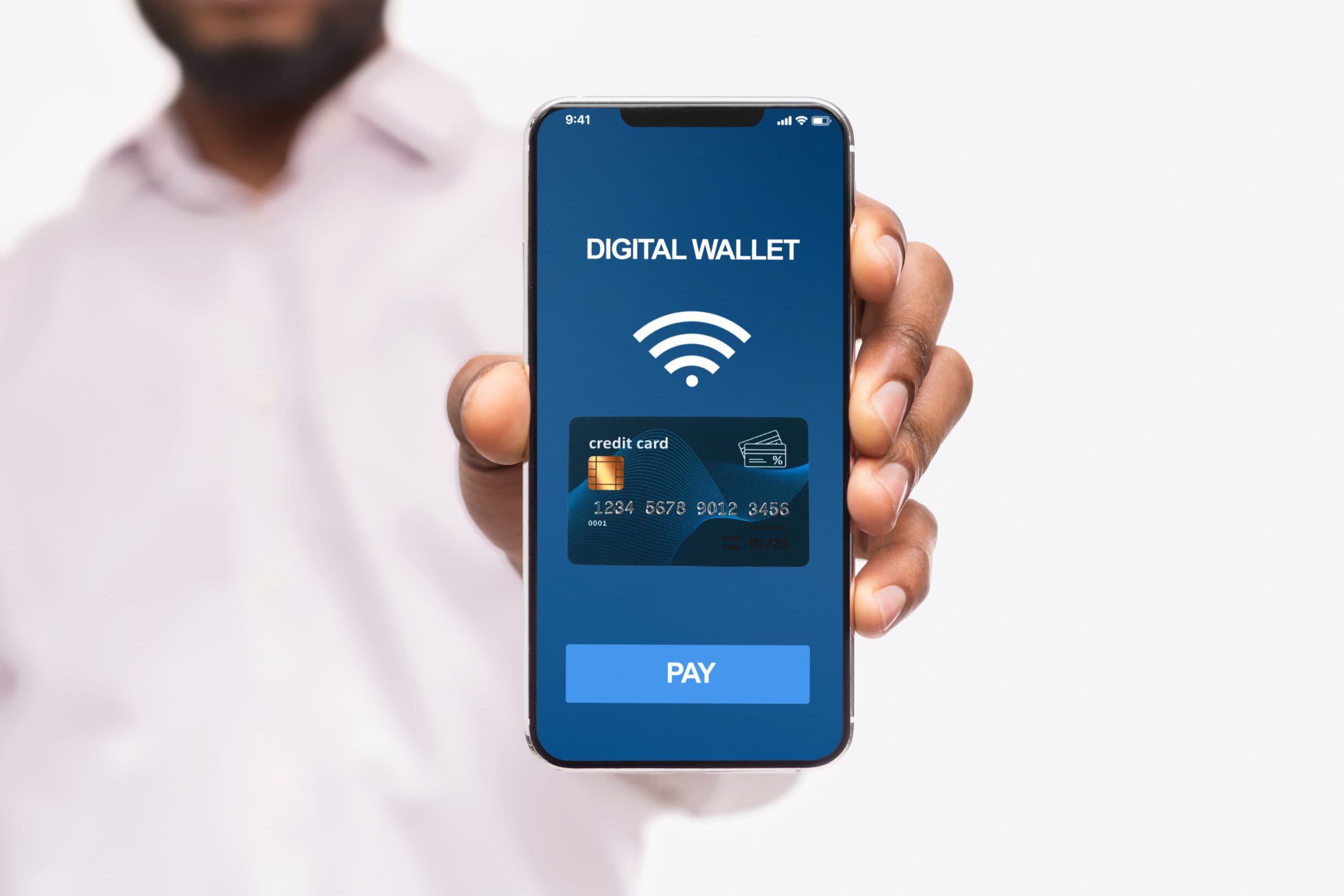 Man holding out a phone showing a digital wallet screen with a saved credit card, contactless symbol and a Pay button
