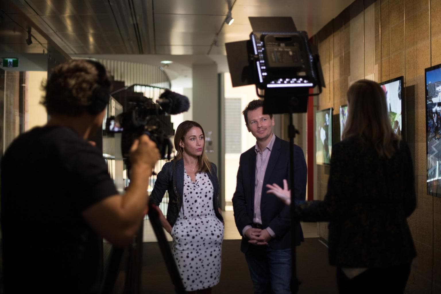 Nathan and Marisol Challen being interviewed on camera in a gallery space.