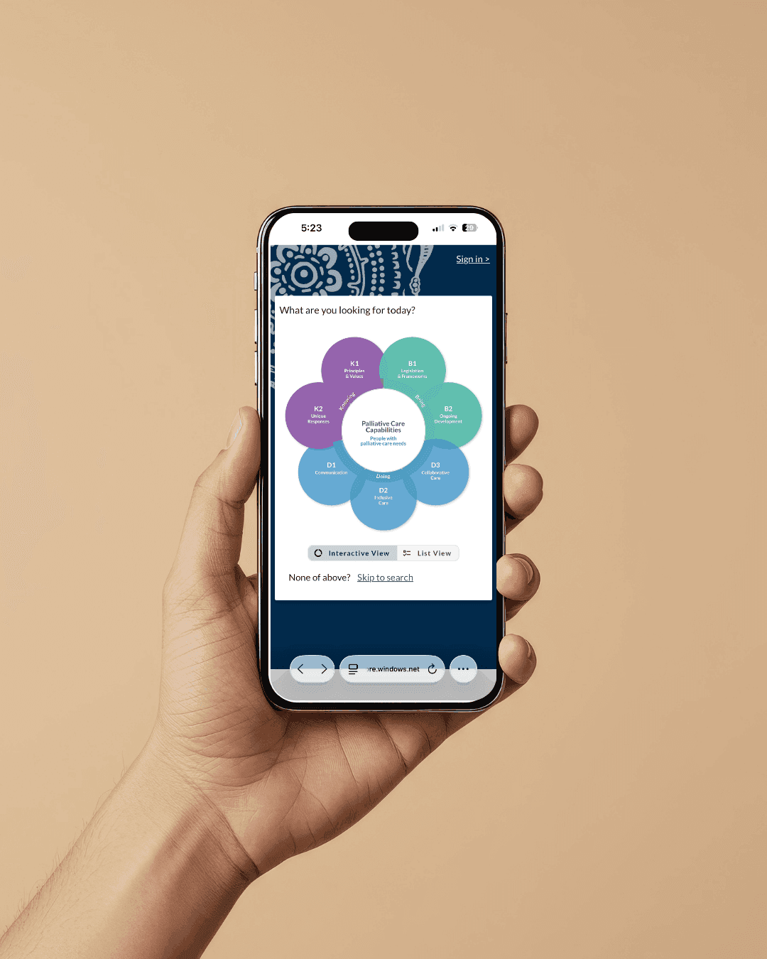 Hand holding a phone showing the PaCE Palliative Care Capabilities flower diagram of knowing, being and doing categories